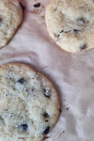 Cottage cheese chocolate chip cookies baked on a lined bakign tray.