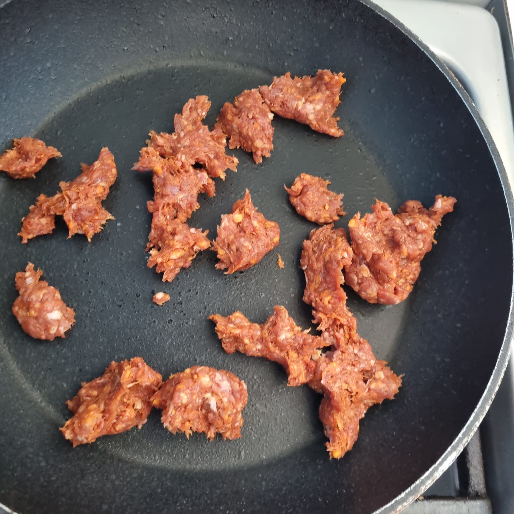 Ground beef in a skillet.